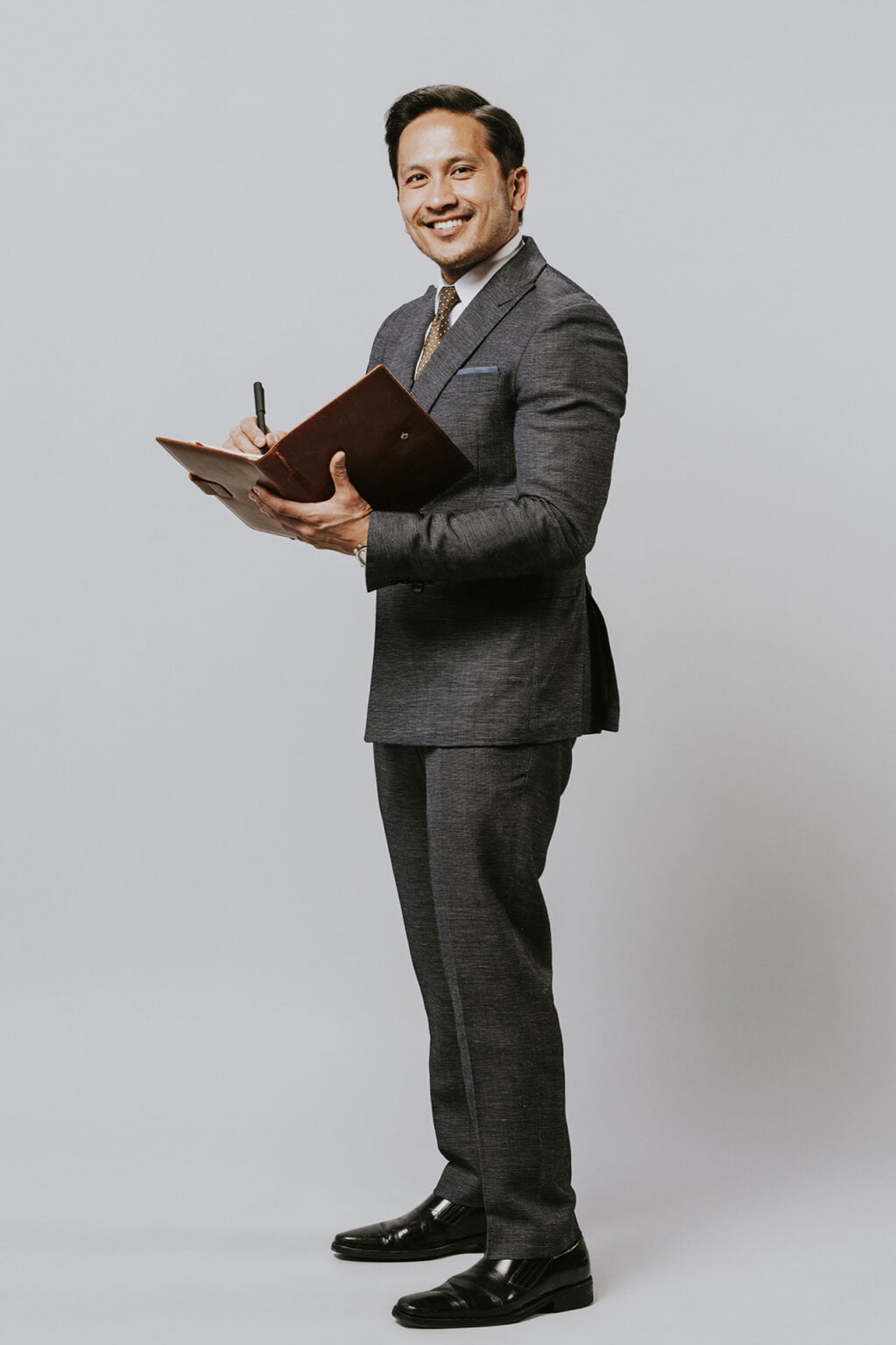 a man in a suit holding a violin