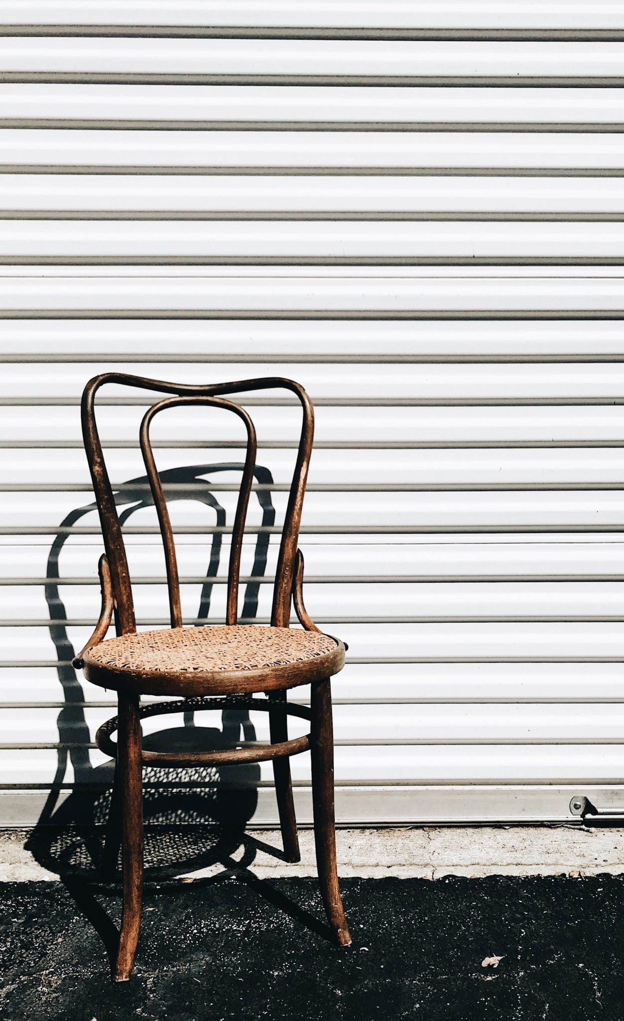 a chair in front of a white wall
